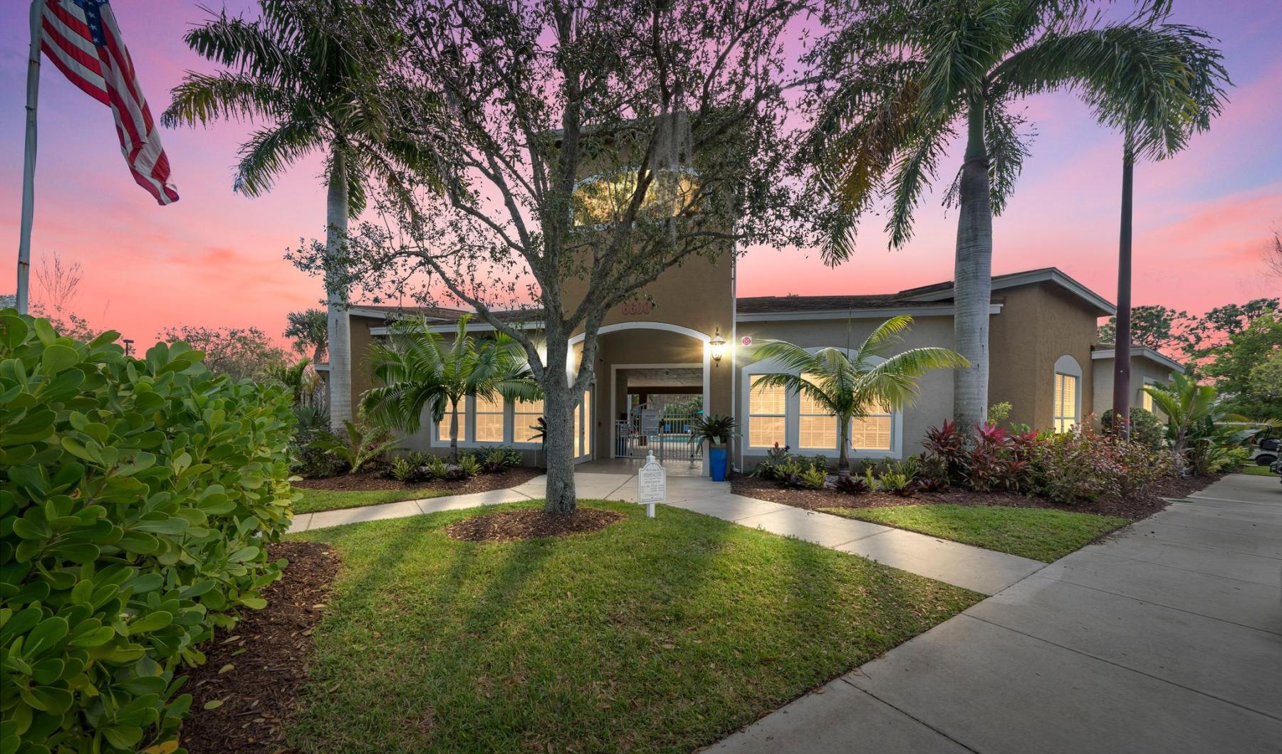 a building with trees and bushes in front of it